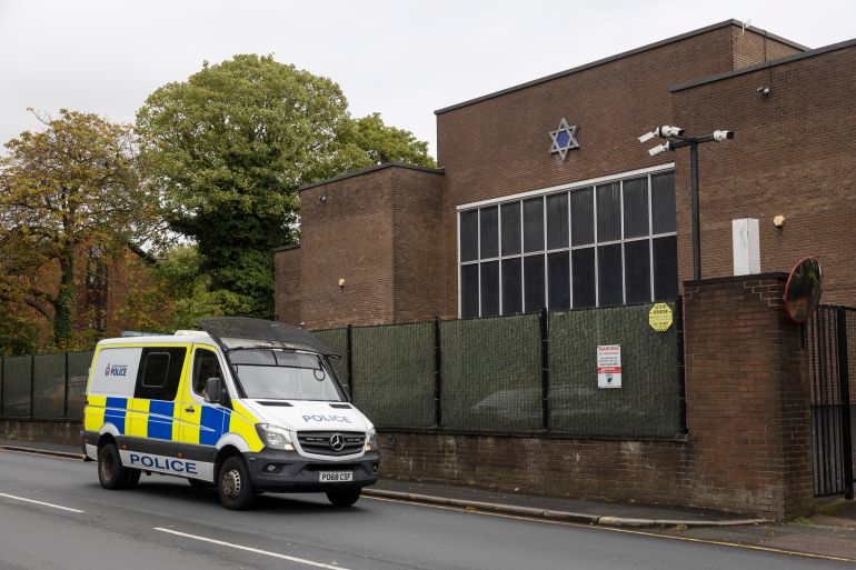 MANCHESTER, ENGLAND - OCTOBER 02: A police car patrols the area around Heaton Park Shul on October 02, 2026 in Manchester, England. Jewish communities across the UK remain on high alert one year after a deadly terrorist attack on the Heaton Park Synagogue in Manchester. On October 2, 2025, Syrian-born British citizen Jihad al-Shamie rammed his car into worshippers and carried out a knife attack at the synagogue during the Jewish holiday of Yom Kippur. Two members of the congregation died in the attack; Melvin Cravitz, 66, was killed by Al-Shamie, while Adrian Daulby, 53, was accidentally shot by police responding to the attack. Members of the synagogue marked the anniversary of the attack on Yom Kippur, which fell on September 21 in the Hebrew calendar this year. (Photo by Ryan Jenkinson/Getty Images)